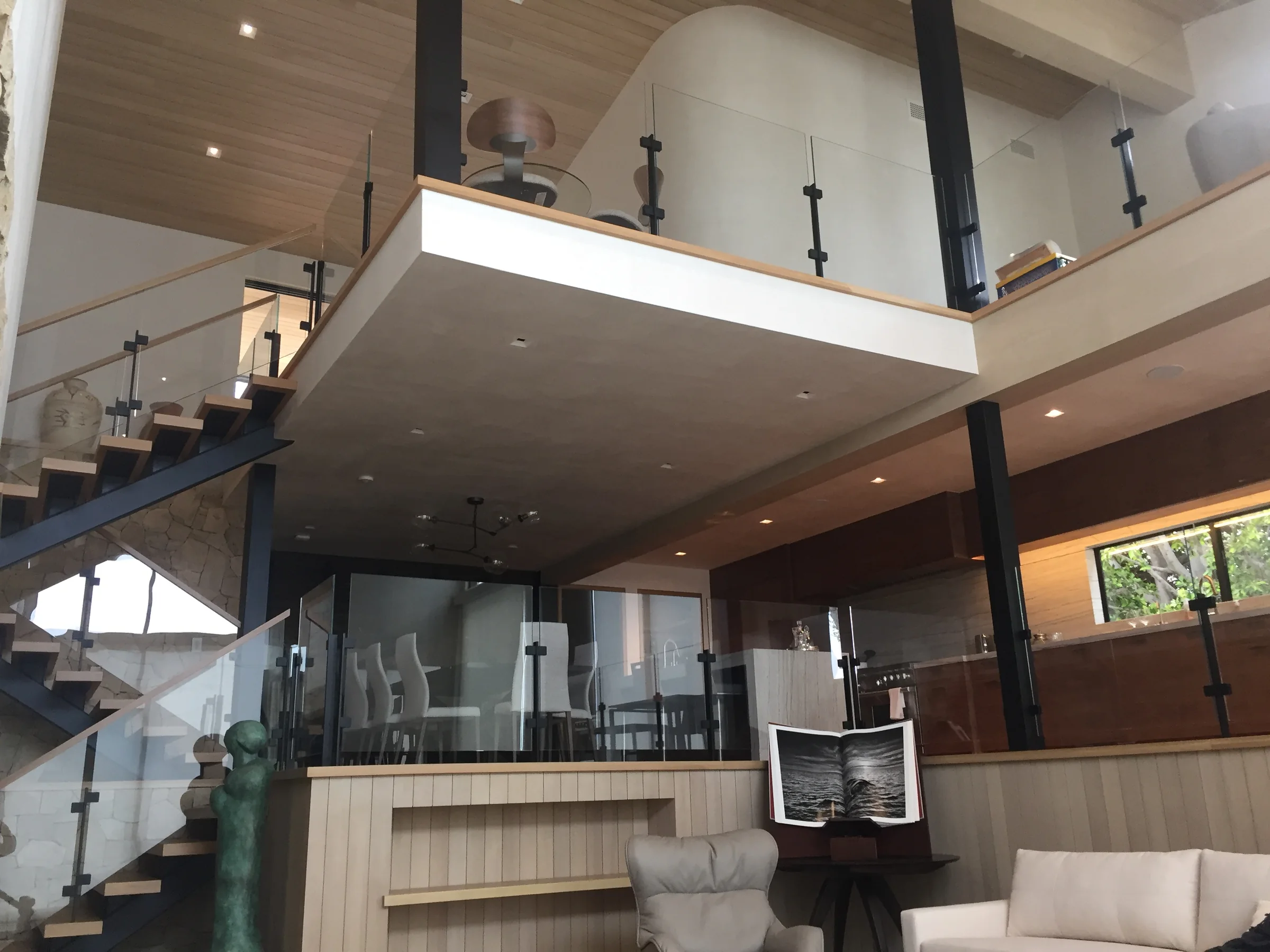 Multilevel home with interior glass railings