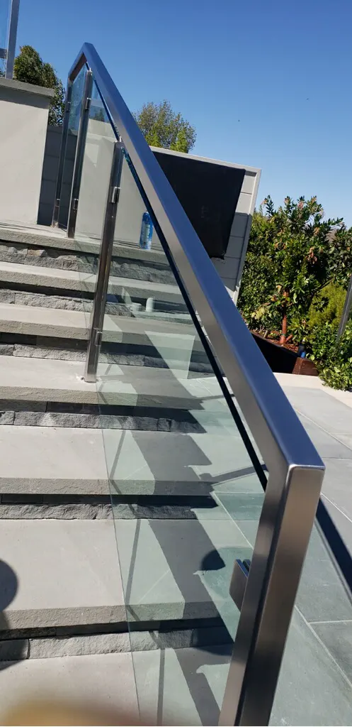 Outdoor stair with glass panels and a stainless steel handrail