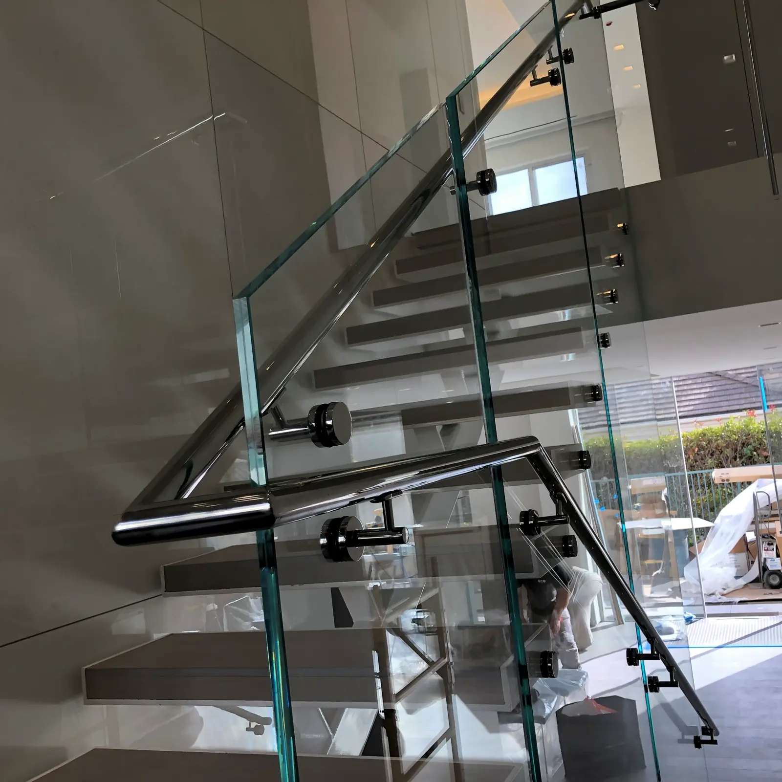 Finished glass stair railing with aligned standoffs