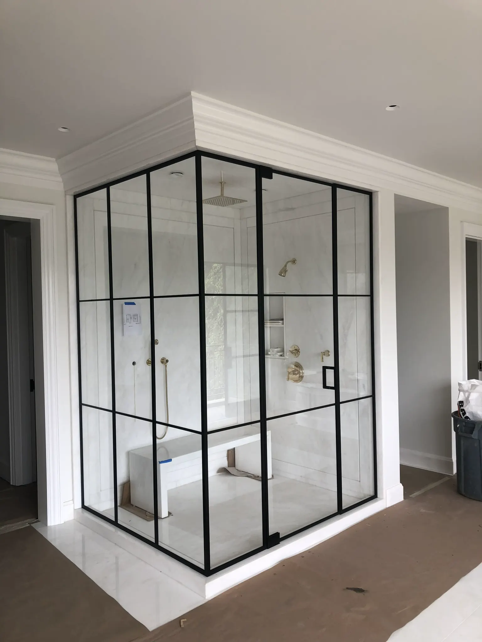 Corner shower enclosure with black metal framing