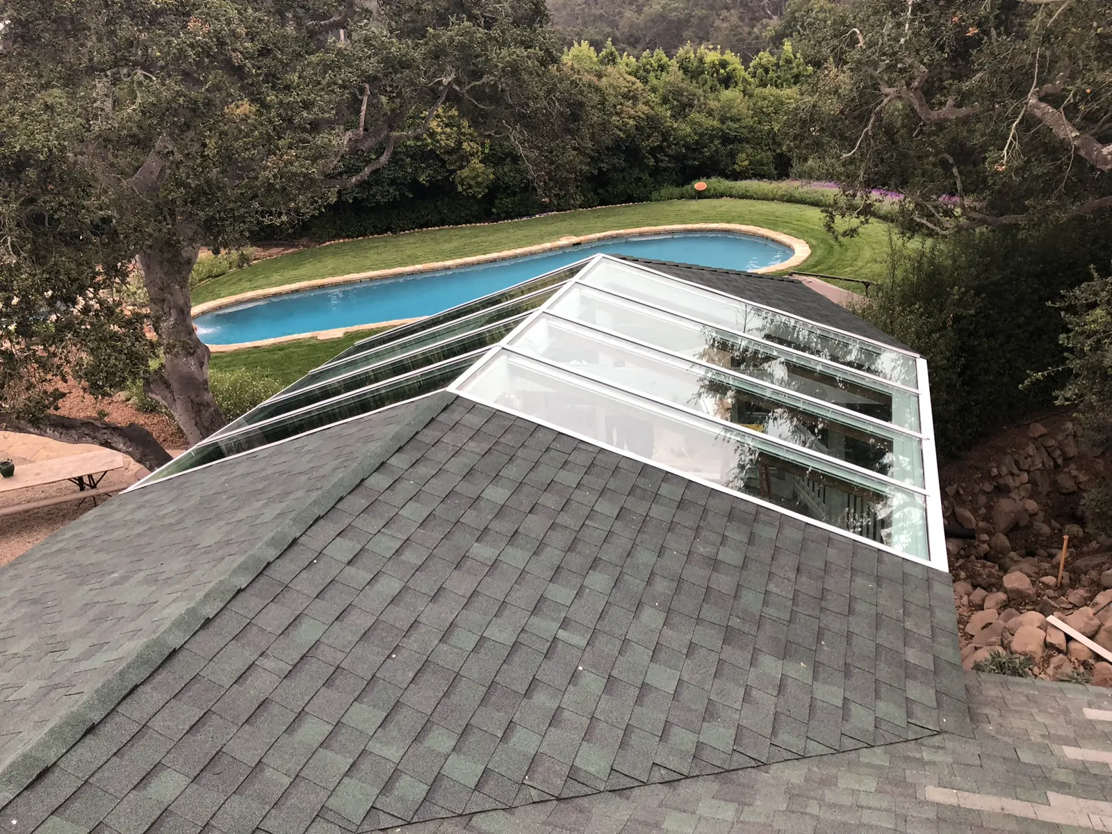 Glass skylight set into a shingled roof